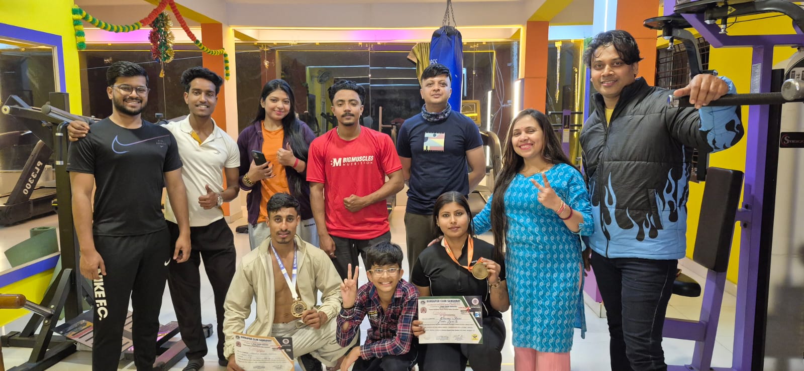 Goldie's Gym members and coaches posing together on the training floor