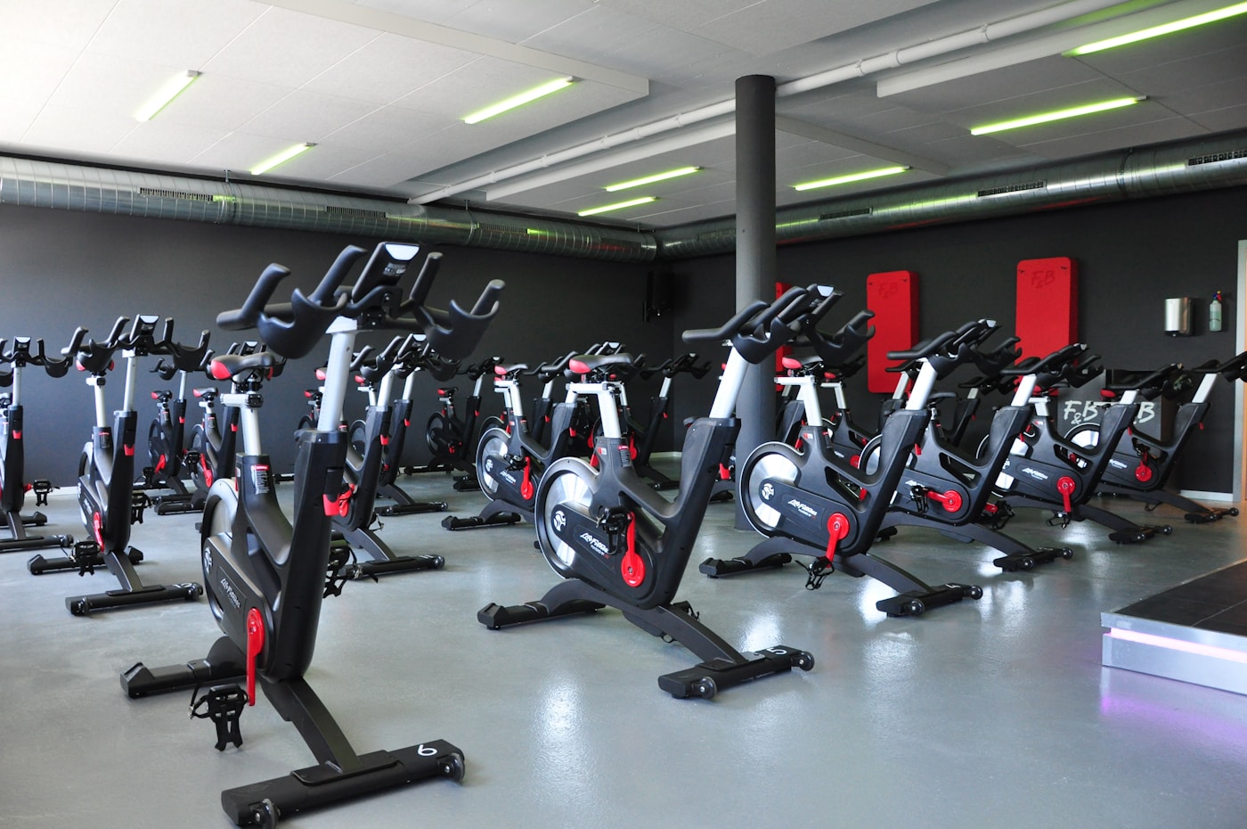 Empty group fitness studio with spin bikes and open floor space